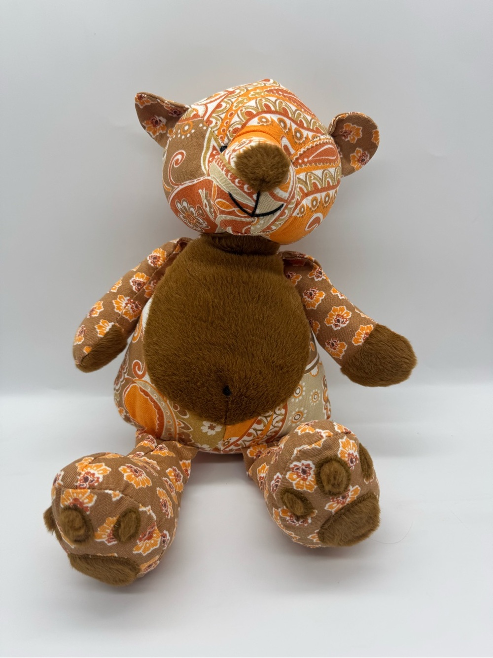 Pier 1 Imports Plush Teddy Bear featuring an orange, tan and white pattern